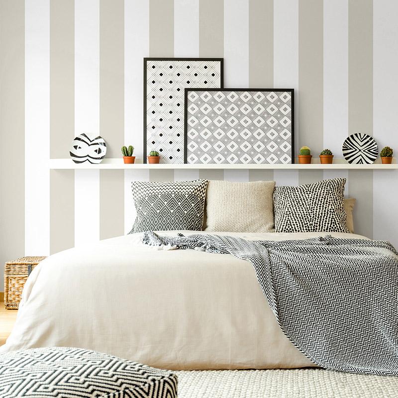 Hammock,Near,Bed,With,Patterned,Blanket,Against,White,Wall,With